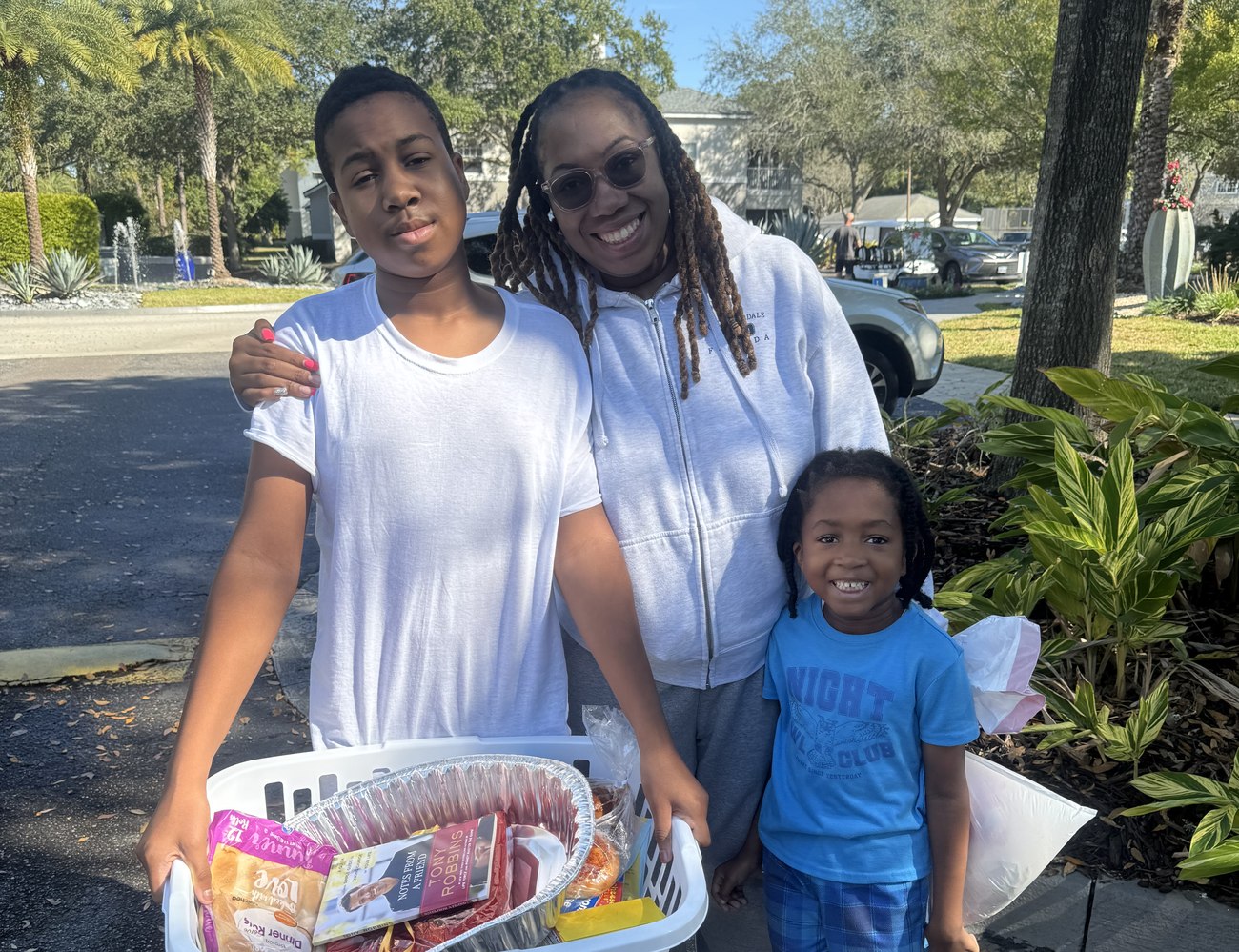 A family supported by the Lone Warrior Foundation receiving a basket of groceries and household provisions