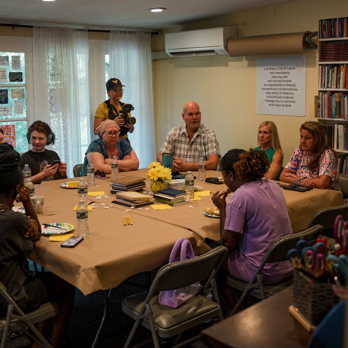 A Lone Warrior community gathering around the table